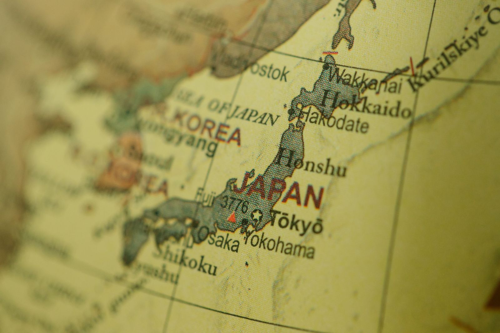 Close-up of a vintage map highlighting Japan and Korea with a selective focus