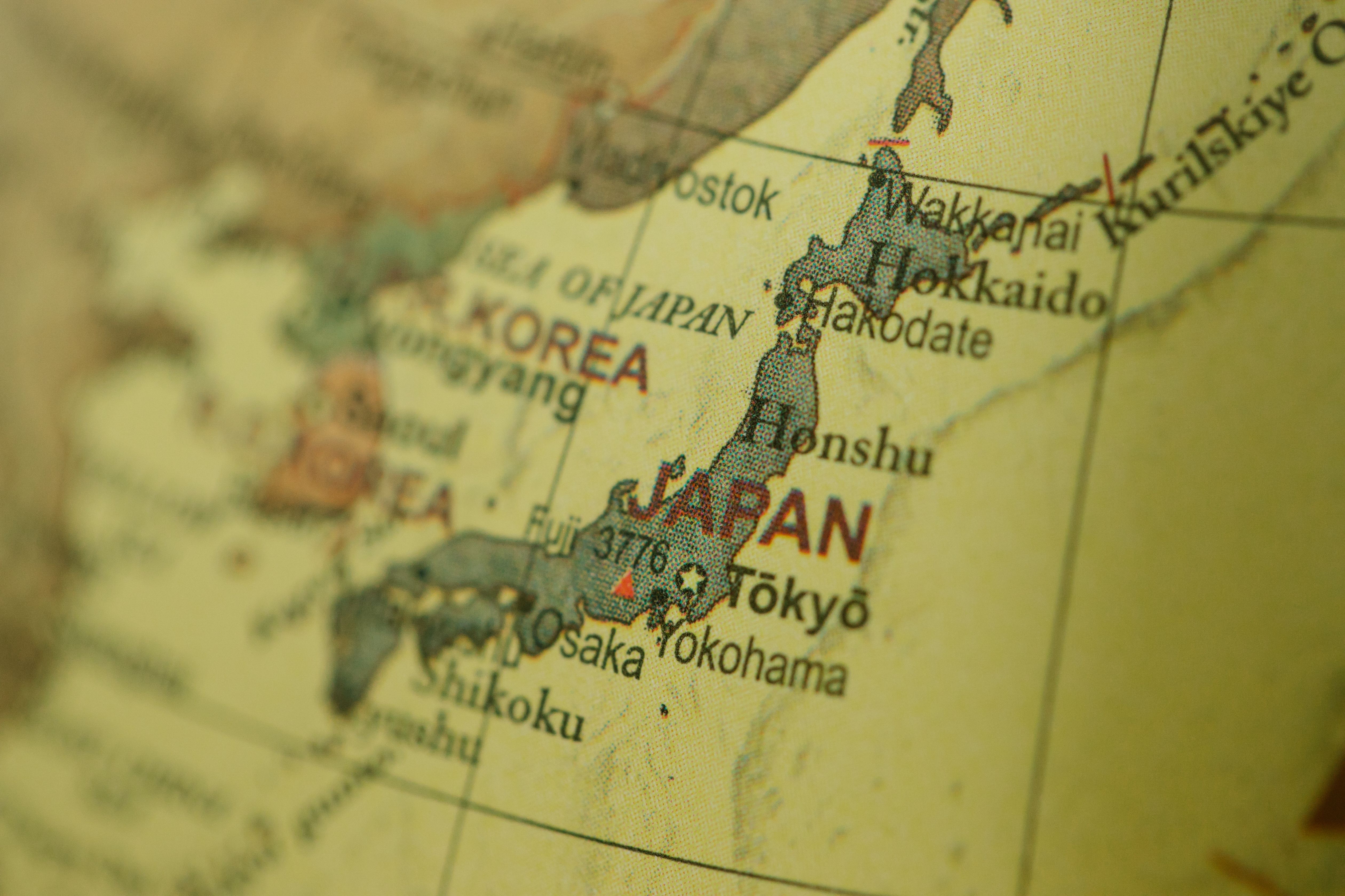 Close-up of a vintage map highlighting Japan and Korea with a selective focus