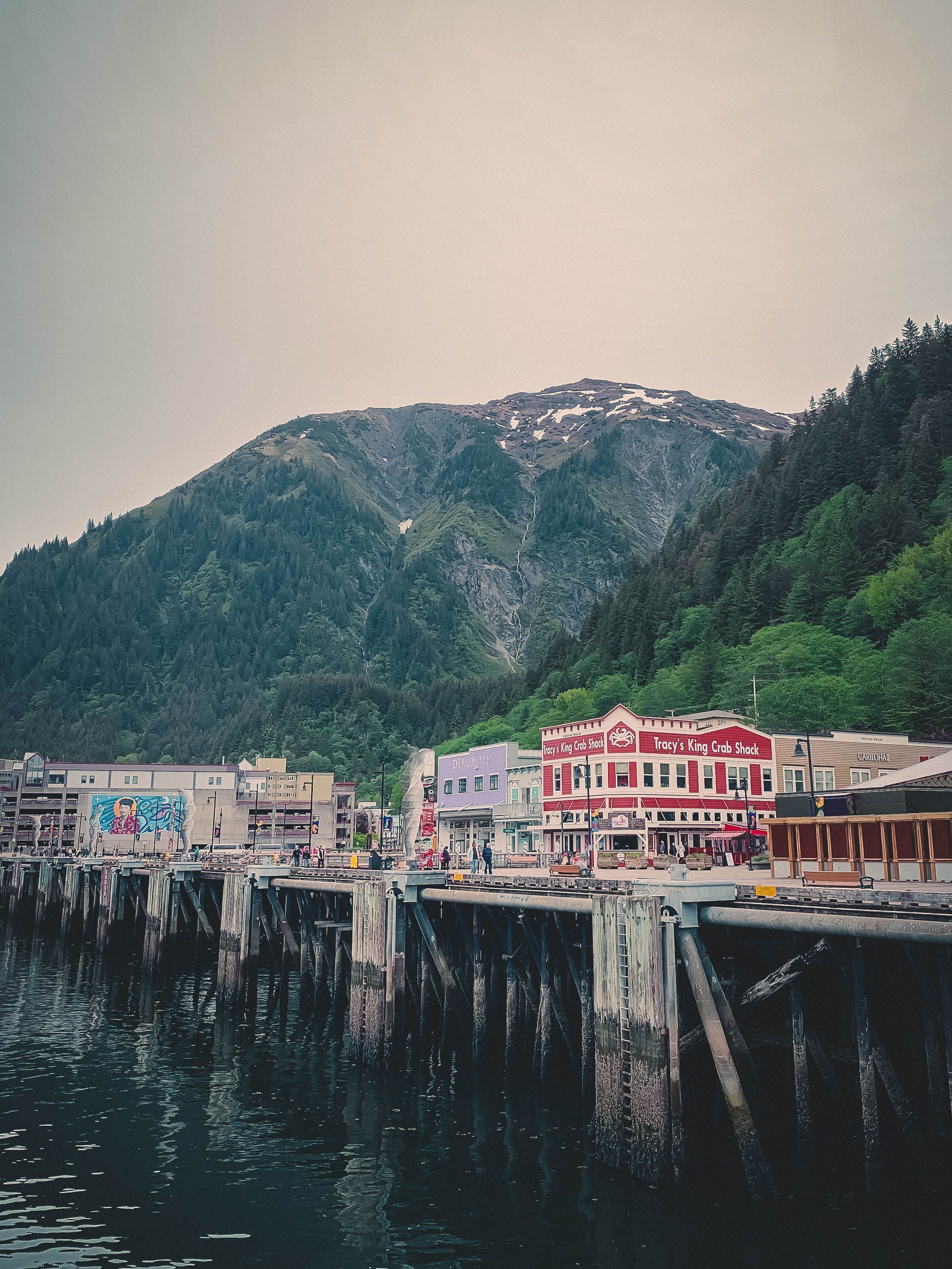 Picturesque view of Juneau's waterfront with lush mountains and colorful buildings